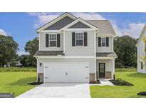 Two-story house with gray siding, white garage door, and landscaped lawn at 431 Prescott Way, Villa Rica, GA 30180