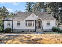 Charming white brick ranch house with a well-manicured lawn at 3199 Mcafee Rd, Decatur, GA 30032