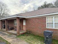 Brick duplex with covered porch and a spacious yard at 241 E Ash St, Social Circle, GA 30025