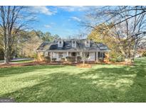 Brick ranch house with a large front yard and mature trees at 606 Ginger Cake Rd, Fayetteville, GA 30214