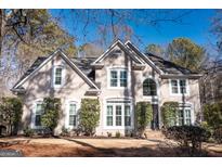 Two-story house with light beige exterior, white trim, and landscaping at 290 Stonehaven Dr, Fayetteville, GA 30215