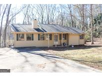 Ranch style home with a spacious yard and a long driveway at 1760 Upland Ridge Nw Dr, Conyers, GA 30012