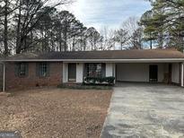 Brick ranch house with carport and mature trees at 213 Sharon Dr, Canton, GA 30115