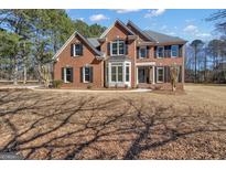Brick two-story house with a large front yard and black shutters at 155 Hedgewick Way, Tyrone, GA 30290