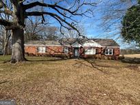Brick ranch house with mature trees and a spacious yard at 526 Mcdonald Rd., Covington, GA 30016