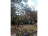 Brick house with attached garage, trees, and a yard at 6238 Lance Ln, Riverdale, GA 30274