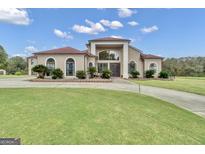 Grand two-story home with a large lawn and driveway at 506 W Mcintosh Rd, Brooks, GA 30205