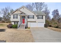 Two-story house with attached garage and red front door at 119 Bombay Ln, Grantville, GA 30220