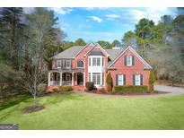 Brick house with large front yard and mature trees at 525 Stonehaven Dr, Fayetteville, GA 30215