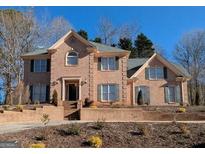 Brick two-story house with a landscaped yard and driveway at 138 Glen Eagle Way, Mcdonough, GA 30253