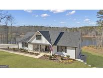 Stunning modern farmhouse with a beautiful lawn and lake view at 459 Lester Rd, Fayetteville, GA 30215