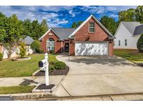 Charming single-story brick home with a well-manicured lawn and inviting curb appeal at 67 Kentucky Ave, Sharpsburg, GA 30277