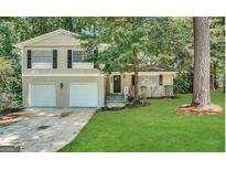 Charming two-story home with a brick facade, attached garage, and a well-manicured lawn at 2296 Aurie Dr, Decatur, GA 30034
