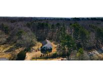 Charming home nestled among mature trees offers a private, serene setting at 116 Appalachee Church Rd, Auburn, GA 30011