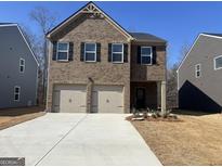 Charming two-story brick home featuring a two-car garage and manicured front yard at 5308 Tolar Rd # 20, South Fulton, GA 30213