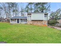 Charming home featuring a well-maintained lawn and unique architecture at 3417 Little Beth Ct, Decatur, GA 30034