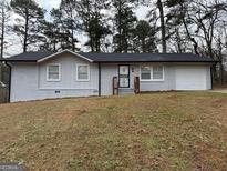 Charming single-story home with a freshly painted exterior and a well-manicured front yard at 3339 Clevemont Ct, Ellenwood, GA 30294