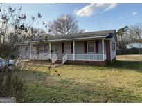 Charming single-story home with a cozy front porch and well-maintained lawn at 376 Lakewood Dr, Social Circle, GA 30025