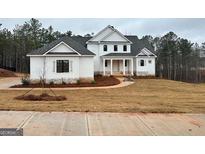 Inviting new construction home with a lush lawn and stone accents at 130 Dockside Dr # 380, Fayetteville, GA 30215