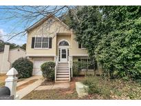 Charming two-story home featuring a welcoming entrance, well-kept lawn, and attached one car garage at 5827 Highgrove Dr, Atlanta, GA 30349