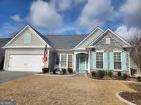 Charming single-story home with stone accents, a two-car garage, and a well-manicured front lawn at 912 Santa Anita Dr, Woodstock, GA 30189