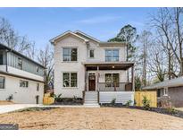 Two-story house with white brick, wood porch, and manicured landscaping at 1055 Ormewood Se Ave, Atlanta, GA 30316