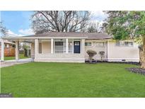 Charming single story home with a well-manicured green lawn and inviting front porch at 3415 Homera Pl, Decatur, GA 30032