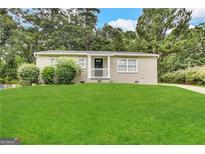 Charming brick home featuring a well-manicured lawn and inviting entrance at 3609 Croft Nw Pl, Atlanta, GA 30331