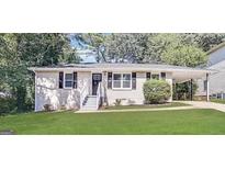 Charming single-story home with a well-maintained lawn, a welcoming entrance, and a convenient carport at 2544 Brentwood Rd, Decatur, GA 30032