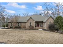Charming one-story brick home featuring a well-manicured lawn and inviting entrance at 50 Red River Ct, Covington, GA 30014