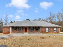 Charming brick home with a symmetrical design and a well-maintained front yard at 445 Turner Dr, Mcdonough, GA 30252