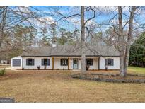 Charming ranch-style home with white siding, black shutters, and inviting front porch at 225 Highway 212 S, Covington, GA 30014