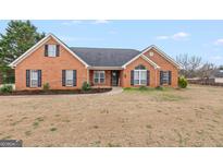 Charming single-story brick home with well-maintained lawn and inviting entrance at 234 Thorne Wood Ln, Hampton, GA 30228