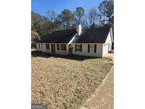 Charming one-story home with white siding, a dark roof and a covered front porch at 263 Rocky Point Rd, Covington, GA 30014