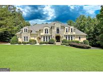 Stunning two-story home with a manicured lawn and beautiful stone and stucco exterior at 709 Prestige Pt, Peachtree City, GA 30269