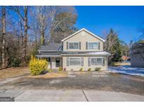 Charming two-story home with a well-manicured lawn and traditional architectural details at 3049 Flat Shoals Rd, Atlanta, GA 30349