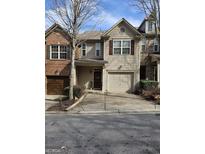 Charming townhouse with attached garage, neat landscaping, and a cozy front entrance at 2764 Keystone Ave, Lithonia, GA 30058