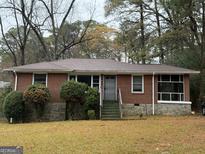 Charming single story brick home with stone foundation and landscaped front yard at 392 Carey Se Dr, Atlanta, GA 30315