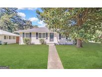 Charming single-story home with a well-maintained lawn and mature tree at 1779 Rosewood Rd, Decatur, GA 30032