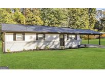 Charming single-story home with a brick foundation, lush green lawn, and a convenient carport at 3507 Sage Dr, Lithia Springs, GA 30122