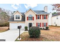 Charming two-story home with beige siding, red shutters, and a well-maintained front yard at 2916 Ward Lake Way, Ellenwood, GA 30294