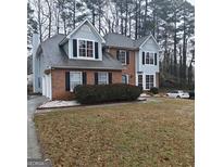 Charming two-story brick home featuring light blue accents, black shutters, and a well-maintained front yard at 10020 Crystal Ter, Jonesboro, GA 30238