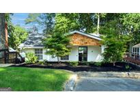 Charming single-story home featuring lush landscaping, black mulch and an inviting entrance at 6337 Lakeview Dr, Buford, GA 30518