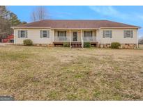 Charming ranch-style home with a welcoming front porch and well-maintained landscaping at 62 Honey Ln, Mcdonough, GA 30252