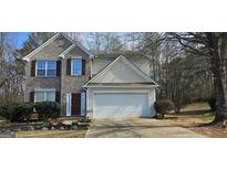 Charming two-story home featuring a two-car garage and a well-maintained front yard at 801 Winbrook Dr, Mcdonough, GA 30253