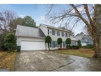 Traditional two-story home with a large two-car garage, a grey roof, and black shutters at 3973 Laurel Bend Dr, Snellville, GA 30039