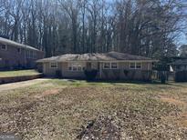 Charming ranch-style home featuring a well-kept lawn and mature trees at 1988 Bencal Se Dr, Atlanta, GA 30316