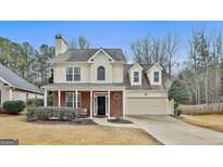 Charming two-story home with a brick front porch and an attached two-car garage at 208 Clifton Ln, Peachtree City, GA 30269