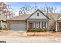 Charming home featuring a stone facade, a two-car garage, and a inviting covered front porch at 250 High Court Way, Locust Grove, GA 30248