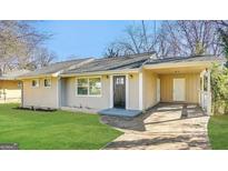 Charming ranch-style home with a covered carport, well-maintained lawn, and inviting front entrance at 2310 Ousley Ct, Decatur, GA 30032
